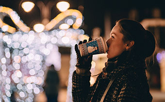 woman drinking seasonal beverage